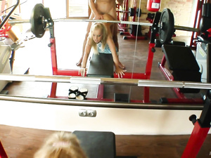 Fucking wildly in the gym is what this sports blonde is fond of. She is tasting and jerking her trainer's cock before getting her holes drilled.