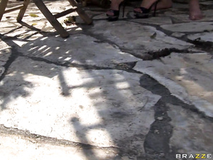 Hot blonde is practicing wild sex with the muscular man wearing the black hat. She is enjoying deep penetration on the white sofa outdoor.