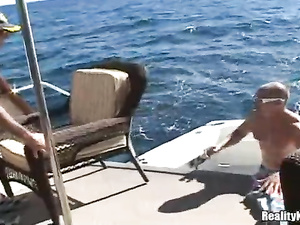 Strong guy wearing black sunglasses is letting this slutty brunette suck his big cock with pleasure. He is also drilling her sweet holes on camera.