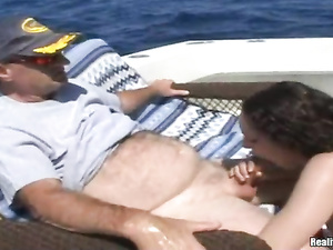 You will never forget this sexy brunette wearing pink bikini. Her lover is getting presented with hardcore fuck session on his own boat.